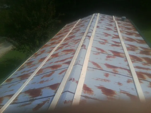 Rusted metal roof panels with new wood purlins before replacement — Storm Damage Roof Repair in Mount Prospect by Roofing Brothers